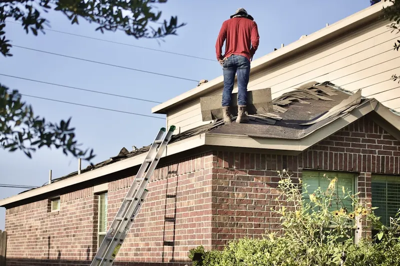 Professional roofer working on a residential roof in Talawanda Springs